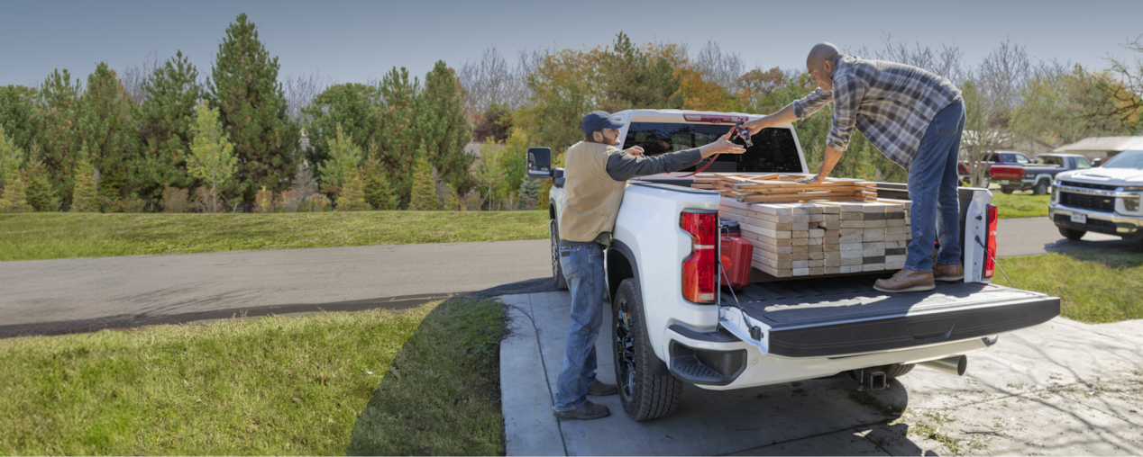 Two Men Loading Up Wood in the Bed of a Chevy Silverado