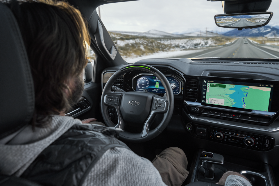 A Man Using Super Cruise Hands-Free Driving Technology in His Chevy Vehicle