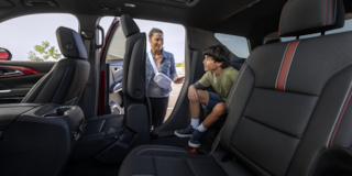 Mother Helping Son out of Back Seat