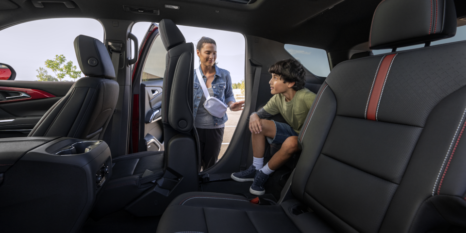 Mother Helping Son out of Back Seat