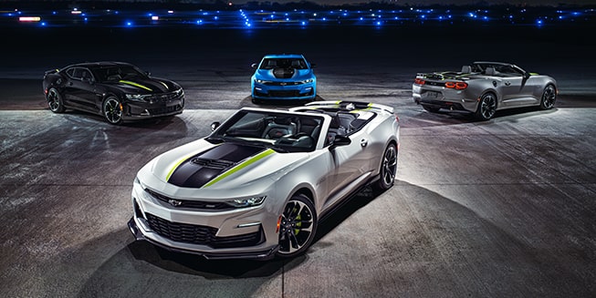 Four Chevrolet Camaro Sports Cars Parked on Display in a Showroom