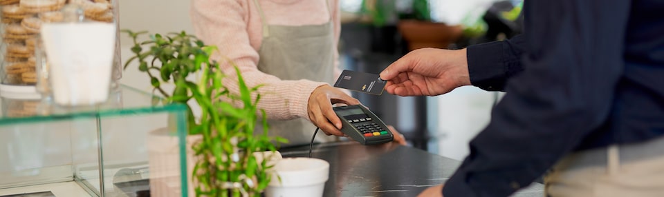 Man Using His My Chevrolet Rewards Card at Coffee Shop to Earn Points