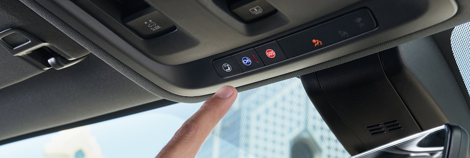 Driver Pressing OnStar Services Button in Chevrolet Vehicle