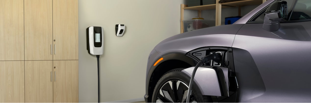 A Silver 2025 Chevrolet EV Is Getting Charged by an Indoor Charging Port