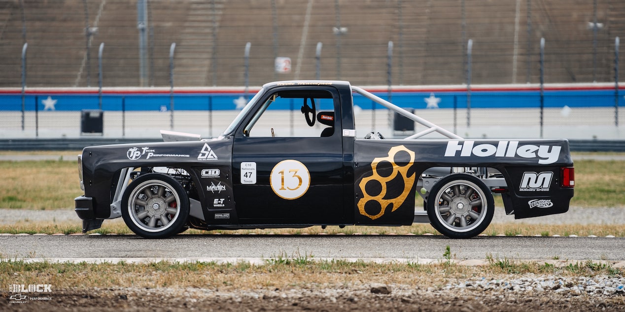 Side View of a 1987 Chevy R10 Truck with Racing Autocross Decals on a Track