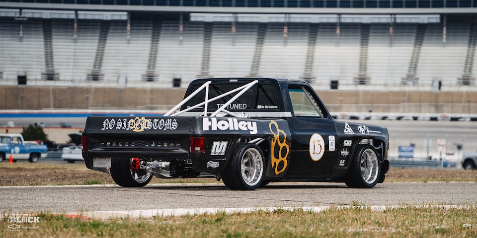 Rear Three-Quarters View of a 1987 Chevy R10 Truck with Racing Autocross Decals