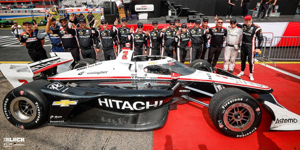 The No. 2 Team Penske crew celebrates after sweeping the weekend at Iowa Speedway with their Chevrolet.