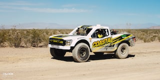 Front Three-Quarters View of Jake Velasco's Off-Roading Truck Driving in the Desert