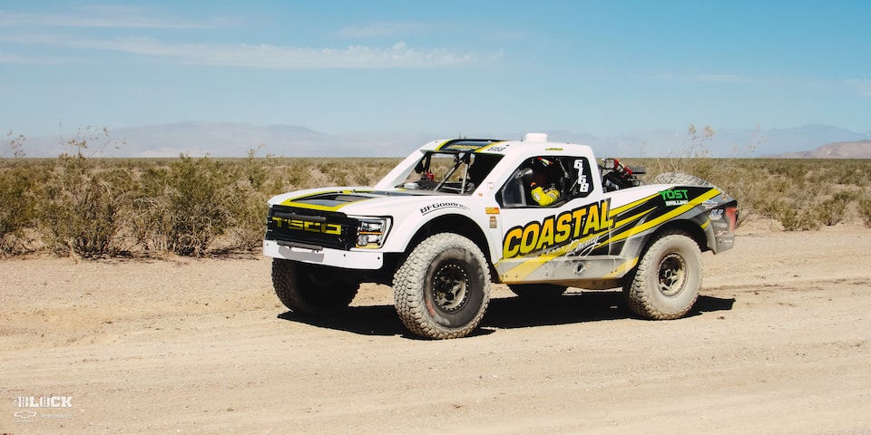 Front Three-Quarters View of Jake Velasco's Off-Roading Truck Driving in the Desert