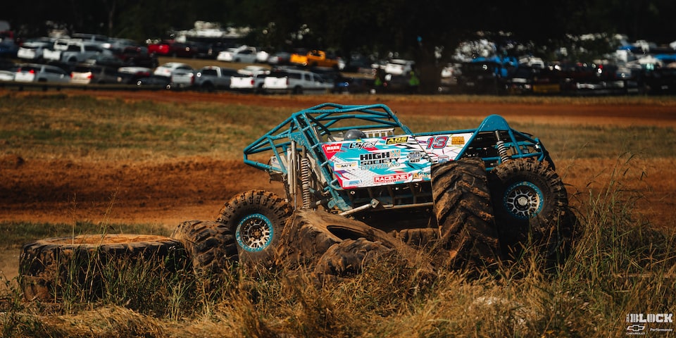 An Off-Road Vehicle Seen Crashed to the Side of a Trail with Discarded Tires Nearby