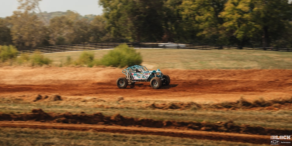 Side View of a Custom off-Road Vehicle Seen from Afar Speeding through the Trail